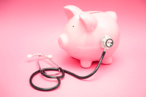 Stethoscope listening to a piggy bank to represent locums staffing savings.