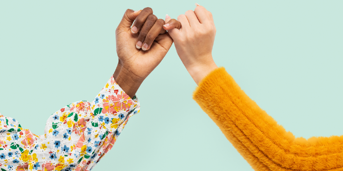 Two hands wrapping their pinkies together to represent healthcare staffing partnerships with Syncx.