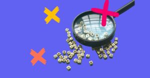 Magnifying glass over letter tiles to represent a glossary of healthcare staffing terms.