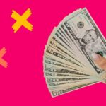 Hand holding a stack of money to represent locums rates.