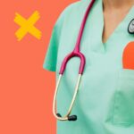 Doctor in scrubs with a paper heart in their pocket to represent non-maleficence.