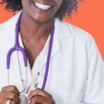 Physician holding stethoscope and smiling.