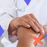 Doctor holding someone's hand to represent physician retention and job satisfaction.