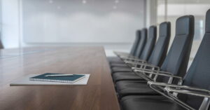 Chairs next to a table in a board room.